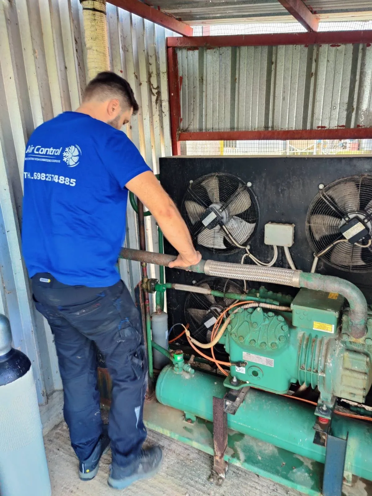 AirControl technician servicing a refrigeration condensing unit